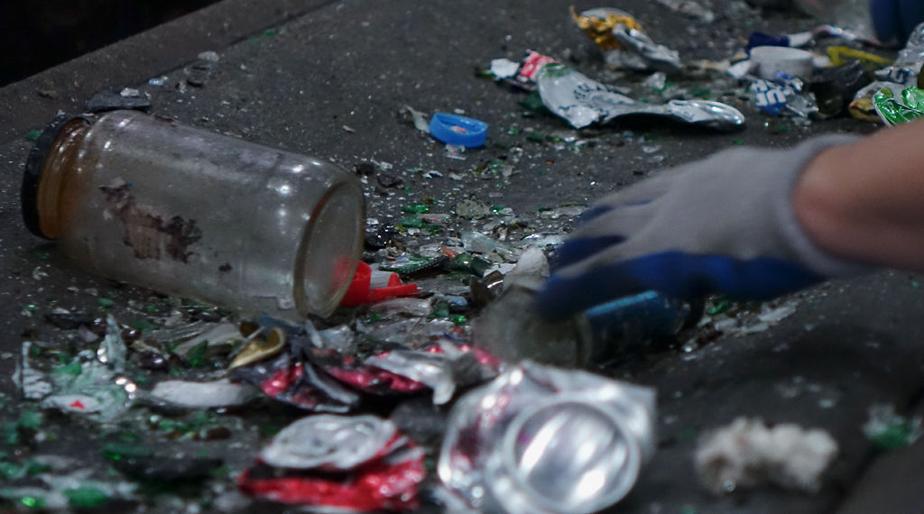 Renee Smith sorts trash at the Material Recovery Facility